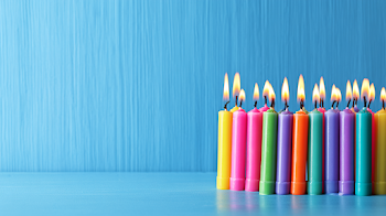 Colorful Birthday Candles on a Light Blue Tabletop