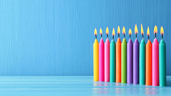 Colorful Birthday Candles on Light Blue Tabletop
