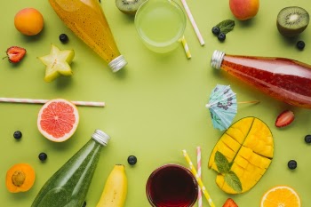 Colorful fruit and juices arrangement Free Photo