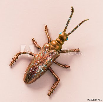 Colorful miniature bug on a paper