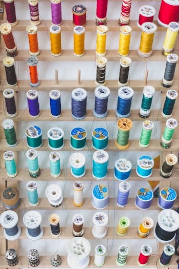 Colorful Sewing Threads On Wall