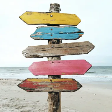 Colorful Wooden Signpost on Beach Colorful Wooden Signpost on Beach