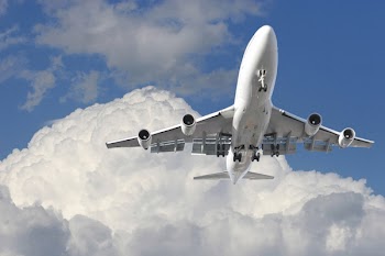 Commercial airplane flying above clouds