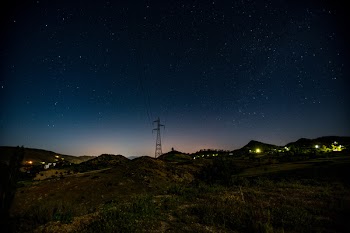 Communication Tower Near Hills at Night
