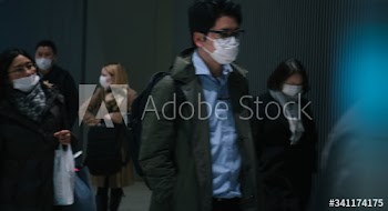 Commuters wearing disposable masks hoping to prevent the spread of corona virus (COVID-19) on February 27th, 2020. Yokohama, Japan.
