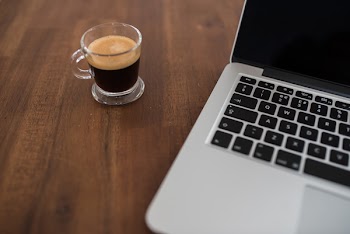 Computer &amp; Espresso Coffee on Wood Desk