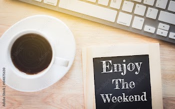 Concept Enjoy The Weekend message on wood boards. A keyboard and a glass coffee table.Vintage tone.