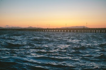 concrete bridge on body of water