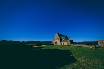 Concrete Building Beside Grass Field