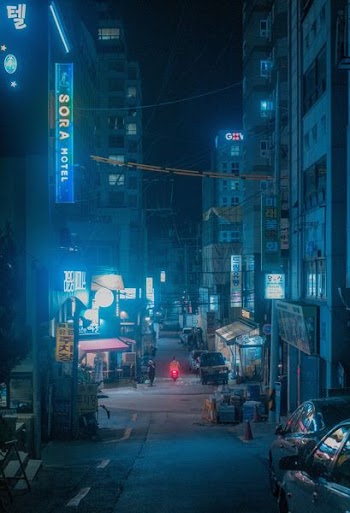 concrete road between buildings at nighttime