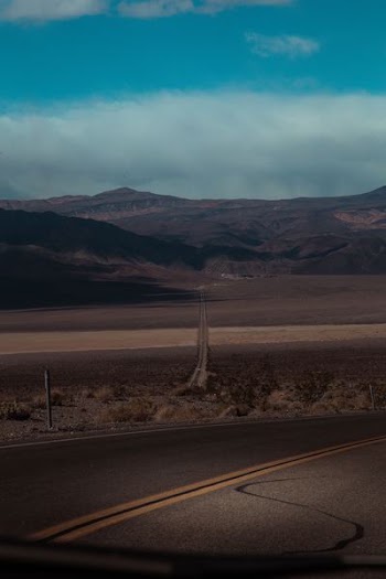 concrete road near hills