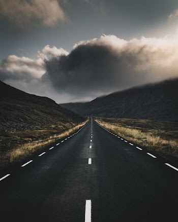 concrete road near mountain