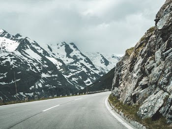 Concrete Road Surrounded Mountains during Golden Hour