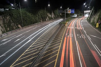 concrete road with street lights during nighttime