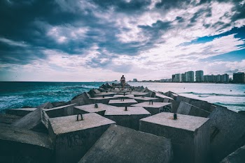 Concrete Slabs on Body of Water Under Cloudy Sky