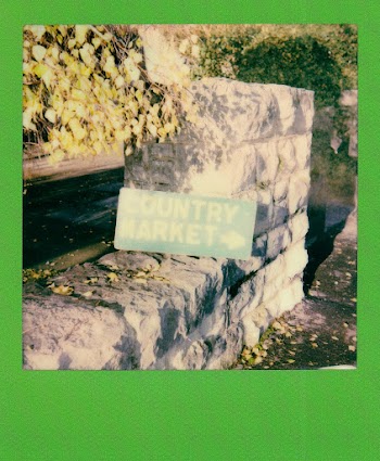 Concrete Wall With Country Market Signboard