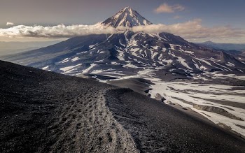 cone-shaped mountain and ice field at daytime