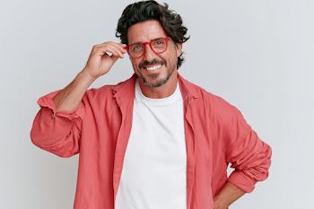 Confident Middle-Aged Man Adjusting Glasses