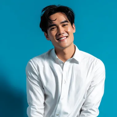 Confident Thai Male Model with Dark Hair Against Vibrant Blue Background Confident Thai Male Model with Dark Hair Against Vibrant Blue Background