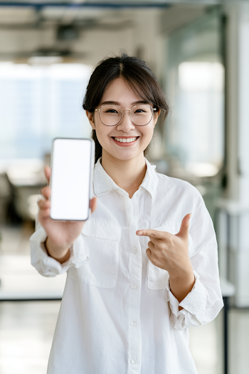 Free: Confident Young Asian Businesswoman Showcasing Smartphone - nohat.cc