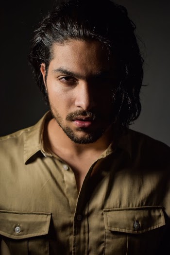 Confident young ethnic male model looking at camera
