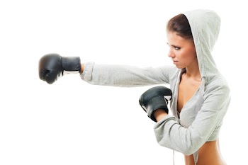 Conident strong woman hit the goal with right hand, boxing, profile view,isolated