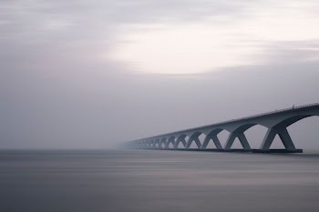 conjunction bridge under white sky