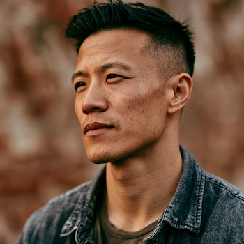 Contemplative Asian Man in Urban Setting