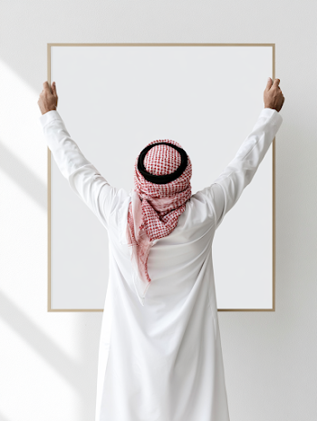Contemplative Middle Eastern Man Holding Empty Picture Frame