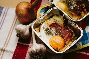 Cooked Food in Square Grey Tray Beside Garlics and Onion
