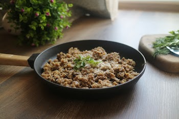 Cooked Food on Frying Fan on Brown Wooden Surface