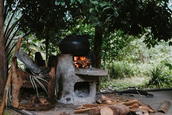 Cooking On A Black Pot Using Firewood