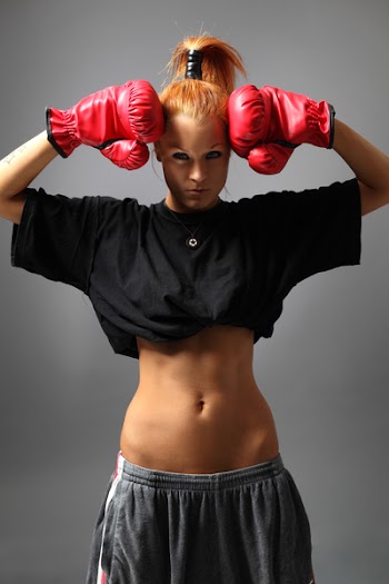 cool sexy female posing in red boxing gloves