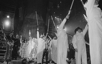 Coronation - Group on Stage Holding Objects above Heads (1 of 3 ...