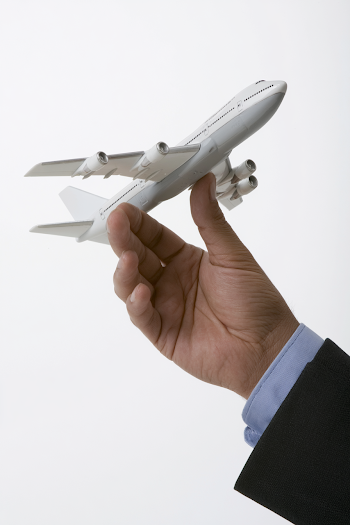 Corporate Aviation Concept: Hand Holding Airplane Model