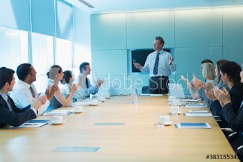 Corporate business people clapping for businessman leading meeting