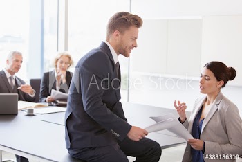 Corporate business people discussing paperwork in conference room meeting