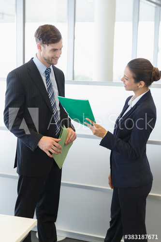 Corporate business people discussing paperwork in office