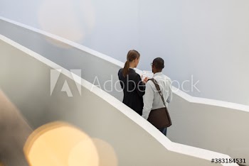 Corporate business people discussing paperwork on modern stairs