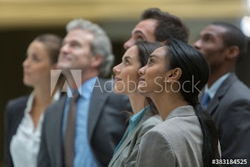 Corporate business people looking up in anticipation