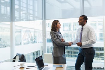 Corporate business people shaking hands in office