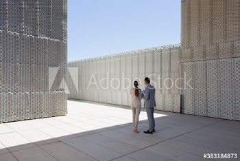 Corporate business people standing in modern courtyard