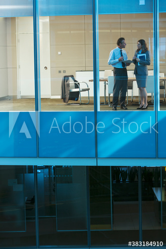 Corporate business people talking at office window