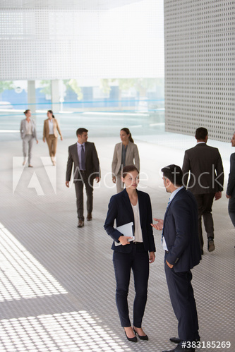 Corporate business people talking in modern lobby