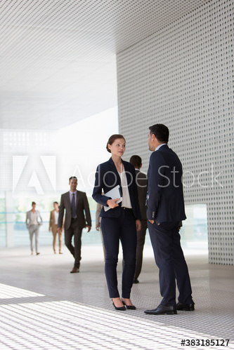 Corporate business people talking in office lobby