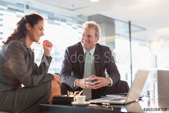 Corporate business people using laptop in meeting