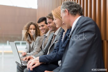 Corporate business people using laptop in office