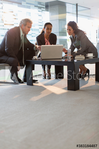 Corporate business people using laptop in office meeting