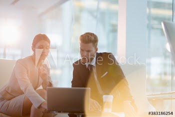 Corporate business people using laptop in office meeting