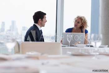 Corporate business people using laptop in restaurant